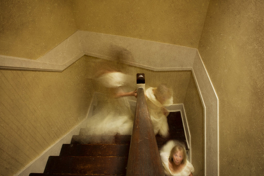 Ghostly Image running Down old Staircase